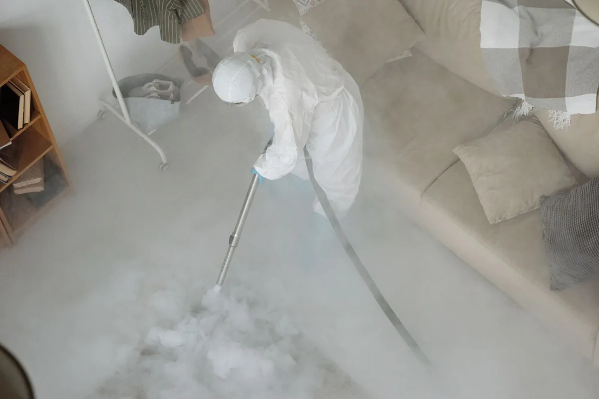 Biohazard cleanup technician in protective equipment, Prunedale, CA